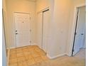 Bright entryway featuring tile flooring, closet, and a solid white front door at 9568 W San Juan Cir # 307, Littleton, CO 80128