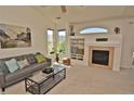 Inviting living room with a fireplace, built-in shelves, and lots of natural light at 9568 W San Juan Cir # 307, Littleton, CO 80128