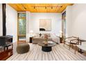 Stylish living room with a cozy wood-burning stove and large windows, complemented by contemporary furniture at 3665 Estes St, Wheat Ridge, CO 80033