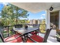 Relaxing balcony view with a table and chairs surrounded by lush greenery and natural light at 2325 S Linden Ct # 318, Denver, CO 80222