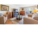 Comfortable living room showcasing an electric fireplace, piano, and access to a balcony at 2325 S Linden Ct # 318, Denver, CO 80222