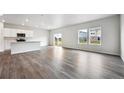 Spacious open-concept living room featuring hardwood floors and ample natural light at 2186 Flower Blossom Ave, Brighton, CO 80601