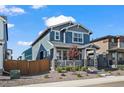 Charming two-story home with a landscaped front yard and inviting front porch at 730 Cottonwood Ave, Bennett, CO 80102