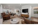 Open-concept living area with hardwood floors and seamless flow to the modern kitchen at 730 Cottonwood Ave, Bennett, CO 80102