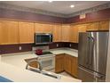Well-equipped kitchen with modern appliances and wood cabinetry and contrasting backsplash at 7369 S Alkire St # 203, Littleton, CO 80127
