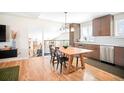 A kitchen with modern appliances and a wooden dining table at 16012 E Floyd Ave, Aurora, CO 80013