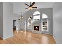 Bright living room with fireplace, high ceilings, and large windows, showcasing an airy atmosphere at 4825 S Ammons St # 133, Littleton, CO 80123