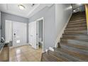 Entryway features neutral colored walls, stairwell and door to the downstairs bathroom at 18619 E 50Th Pl, Denver, CO 80249