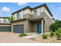 Charming two-story home featuring brick driveway and colorful front door at 18619 E 50Th Pl, Denver, CO 80249