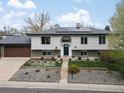 Well kept split level home with solar panels, fresh yard, and an open driveway at 11165 W 58Th Ave, Arvada, CO 80002