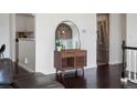 Hallway view showcases a midcentury modern-style cabinet, mirror, and view into modern kitchen at 11165 W 58Th Ave, Arvada, CO 80002