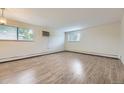 Spacious living room with wood floors, large windows, and neutral wall colors at 5995 W Hampden Ave # 2G, Denver, CO 80227