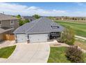 A beautiful aerial view of the property and surrounding neighborhood with a lush green lawn at 16485 E 117Th Ave, Commerce City, CO 80022