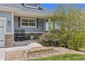 A charming front porch with rocking chairs and decorative plants, perfect for relaxing outdoors at 16485 E 117Th Ave, Commerce City, CO 80022