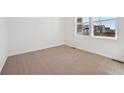 Bright bedroom with neutral carpet and large window, perfect for relaxation at 230 Lark Sparrow Way, Bennett, CO 80102