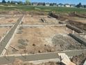 New home construction showing the foundation and initial building phase on a sunny day at 1222 S Algonquian St, Aurora, CO 80018