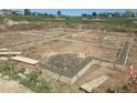 The foundation shows a formed foundation with reinforcement steel, ready for the next stage of building construction at 1222 S Algonquian St, Aurora, CO 80018