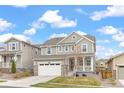 Beautiful two-story home featuring a well-kept lawn, and a modern architectural design against a bright sky at 16108 Red Bud Loop, Parker, CO 80134