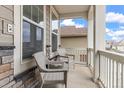 Cozy front porch featuring wicker chairs, perfect for relaxing outdoors with stone and wood accents at 16108 Red Bud Loop, Parker, CO 80134