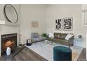Cozy living room boasts a fireplace, stylish furniture, modern decor, and plenty of natural light at 16986 E Piedmont Dr # A, Aurora, CO 80015