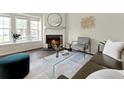 Comfortable living room area features a fireplace, a round mirror, and bright natural light at 16986 E Piedmont Dr # A, Aurora, CO 80015