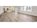 Spacious living room with vinyl plank flooring and abundant natural light at 5553 Wisteria Ave, Firestone, CO 80504