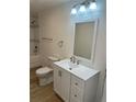 Bathroom features a single sink vanity, a toilet, and a shower and bath tub combination at 805 Park Ave, Fort Lupton, CO 80621