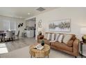 Bright living room with stylish decor, including a comfortable sofa, coffee table, and modern artwork at 141 S Knox Ct, Denver, CO 80219