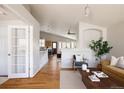 Bright living space with wood floors open to the kitchen and adjacent to a dining area at 2140 Santa Fe Dr, Longmont, CO 80504