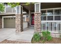 Inviting front porch with stone pillars and a red front door welcomes you home at 9272 Melborne Ct, Parker, CO 80134