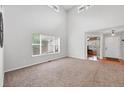 Bright living room with large window and neutral tones, perfect for relaxation at 9272 Melborne Ct, Parker, CO 80134