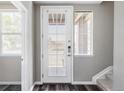 Bright entryway featuring wood floors, staircase, and a glass door with natural light streaming through at 9490 W 14Th Ave # 3, Lakewood, CO 80215