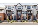 Attractive townhouse exterior showcasing multiple units, each with a small balcony and well-kept landscaping at 9490 W 14Th Ave # 3, Lakewood, CO 80215
