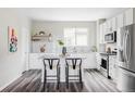 Contemporary kitchen featuring stainless steel appliances, white cabinets and a gray countertop island with seating at 9490 W 14Th Ave # 3, Lakewood, CO 80215