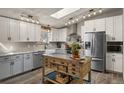 Bright kitchen features stainless steel appliances, subway tile backsplash and a kitchen island with butcher block top at 2859 Cagle Dr, Larkspur, CO 80118
