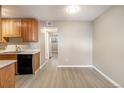 The open-concept dining room has neutral walls, vinyl floors, and flows into the kitchen area at 10792 E Exposition Ave # 154, Aurora, CO 80012