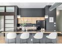 A well-appointed kitchen featuring stone countertops, a breakfast bar, and stainless steel appliances at 2501 15Th St # 2C, Denver, CO 80211