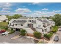 Exterior view of condo building with multiple units and well-maintained landscaping at 1820 Newland Ct # 310, Lakewood, CO 80214
