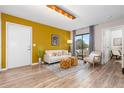 Bright living room with hard wood floors, a white sofa, and a sliding glass door to a patio at 1820 Newland Ct # 310, Lakewood, CO 80214