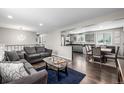 Spacious living room with hardwood floors, open access to the dining room and updated kitchen at 3134 S Fairplay St, Aurora, CO 80014