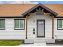 Inviting home entrance featuring a covered front porch with new light fixtures and house number at 22 S Harlan St, Lakewood, CO 80226
