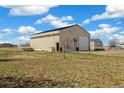 Large barn with roll-up doors and ample space for storage or workshop use on a well-maintained lot at 56330 E 37Th Ct, Strasburg, CO 80136