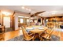 Comfortable dining area showcasing hardwood floors, a round table with seating for four, and open access to the kitchen at 43388 Somerset Ct, Elizabeth, CO 80107