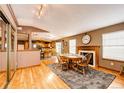 Cozy dining area with fireplace and wood floors adjacent to the open kitchen at 43388 Somerset Ct, Elizabeth, CO 80107