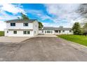 Expansive home featuring bright white siding, well-kept lawn and extra parking perfect for multiple vehicles or RV storage at 43388 Somerset Ct, Elizabeth, CO 80107
