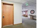Condo hallway with neutral carpet, light walls, and door number 107 at 534 E 7Th Ave # 107, Denver, CO 80203