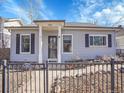 Attractive single-story home with fenced front yard and covered entry at 5920 S Bemis St, Littleton, CO 80120