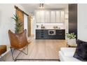 Open living area with stylish sliding door, modern cabinetry, and a comfortable chair at 1922 E 18Th Ave, Denver, CO 80206