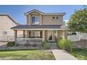Charming two-story home with a covered front porch, complemented by lush landscaping at 11832 Zenobia Loop, Westminster, CO 80031