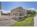 Charming two-story home with a well-manicured lawn and inviting covered front porch at 11832 Zenobia Loop, Westminster, CO 80031